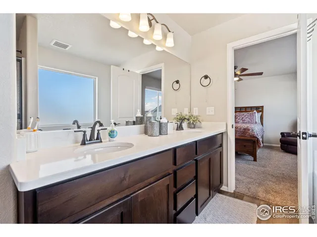 a bathroom with a sink double vanity and a mirror