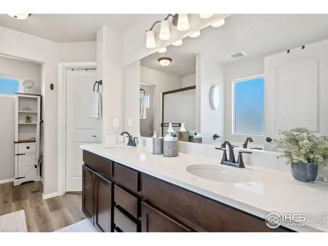 a bathroom with a sink double vanity granite and a mirror