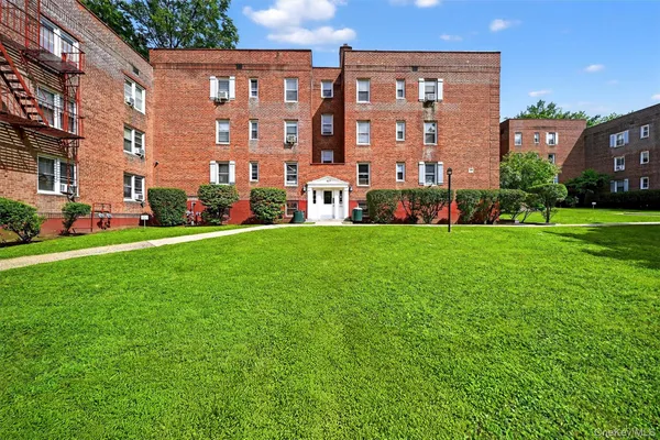 a large building with a yard in front of it