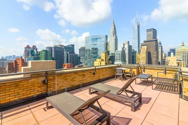 a view of a chairs and table in a balcony