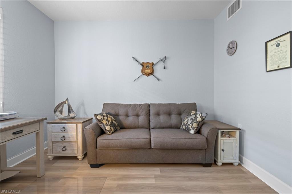 19081 Ridgepoint Drive, Unit 102 Estero, FL 33928 - Photo 12 of 50 a living room with furniture and a couch