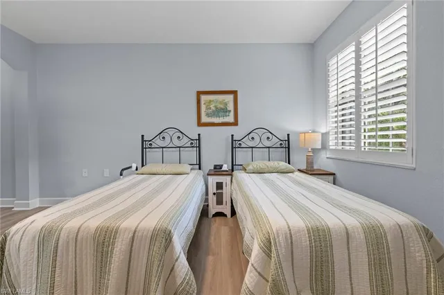 a bedroom with two beds and a window