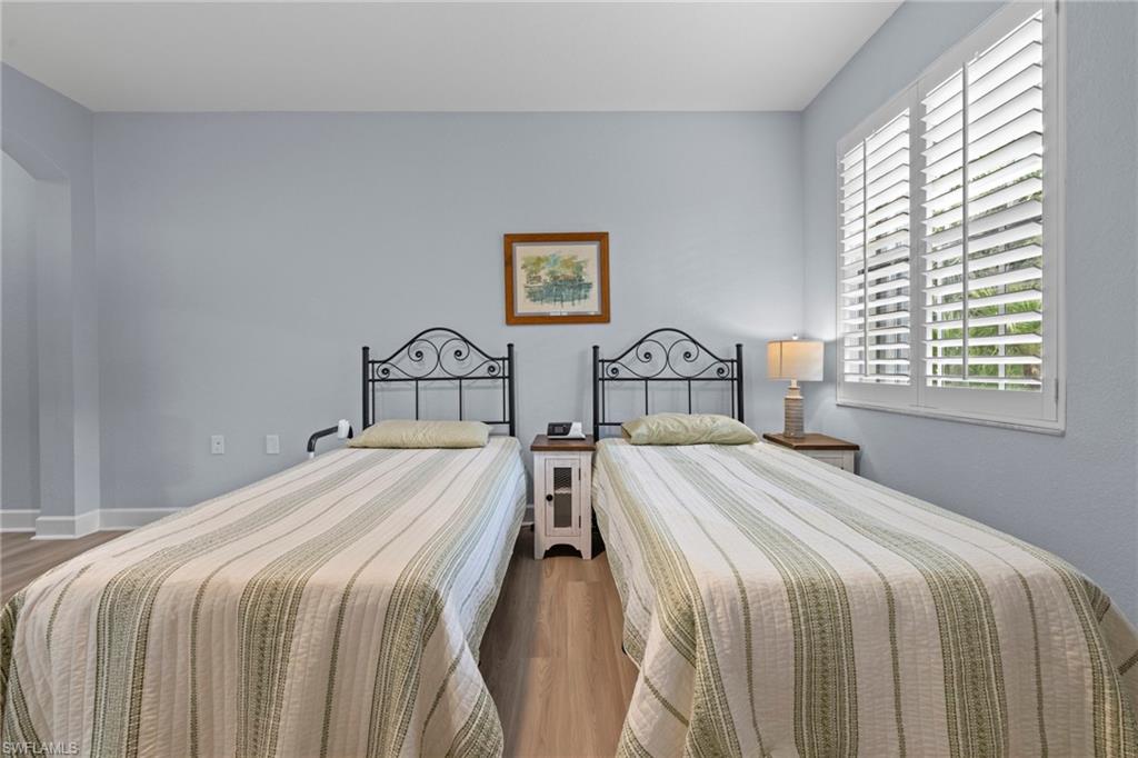 19081 Ridgepoint Drive, Unit 102 Estero, FL 33928 - Photo 13 of 50 a bedroom with two beds and a window