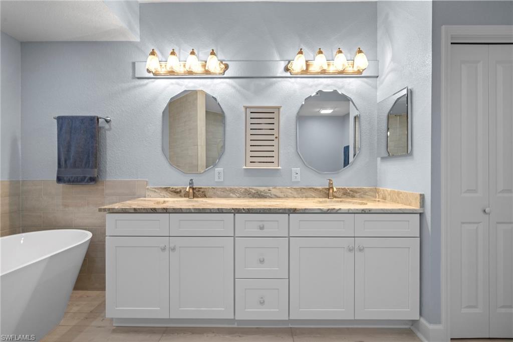 19081 Ridgepoint Drive, Unit 102 Estero, FL 33928 - Photo 16 of 50 a bathroom with a sink and a mirror