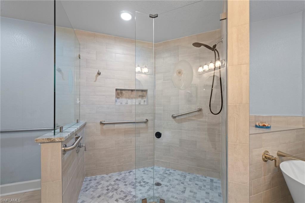 19081 Ridgepoint Drive, Unit 102 Estero, FL 33928 - Photo 17 of 50 a bathroom with a shower and a toilet