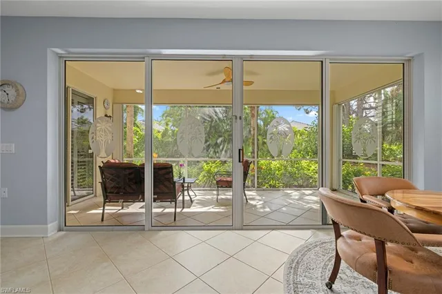 a living room with a large window and a table