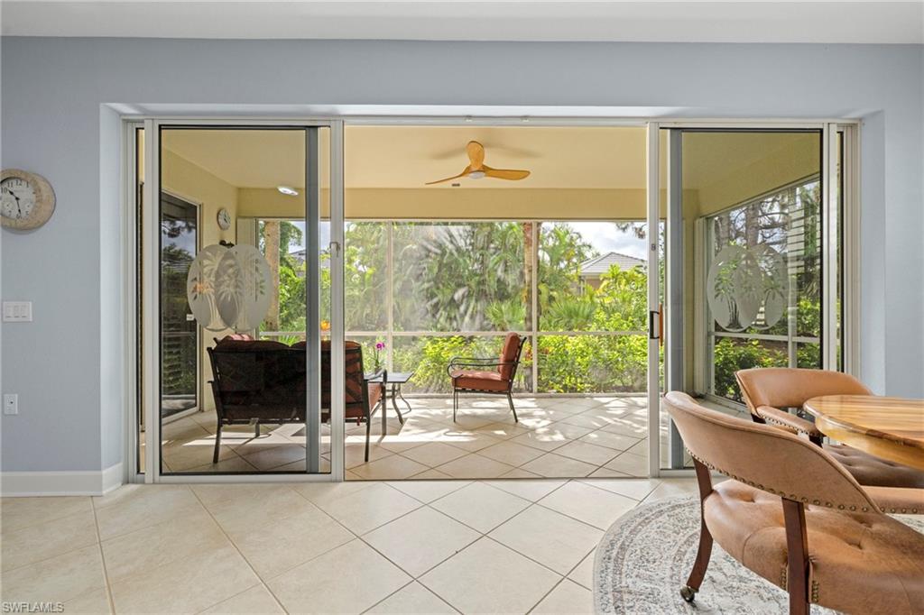 19081 Ridgepoint Drive, Unit 102 Estero, FL 33928 - Photo 19 of 50 a living room with a large window and a table