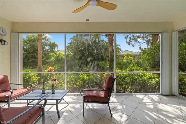 a view of a chairs and table in patio with a yard