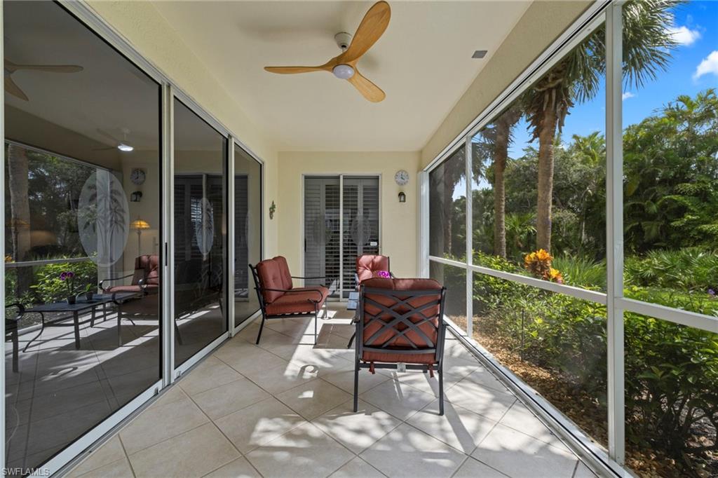 19081 Ridgepoint Drive, Unit 102 Estero, FL 33928 - Photo 21 of 50 a balcony with chairs and glass door