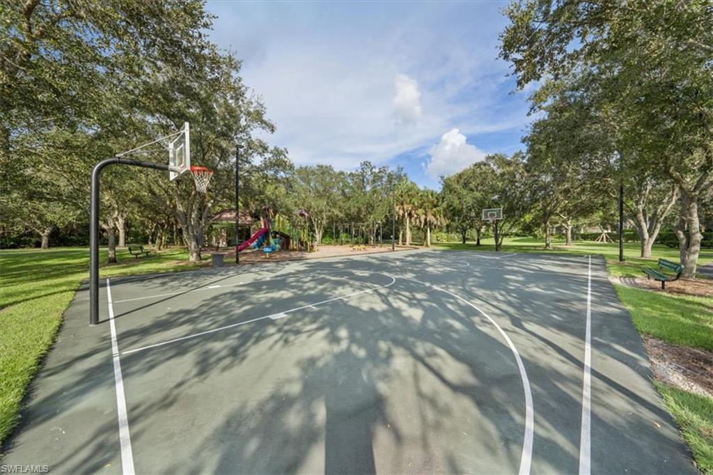 19081 Ridgepoint Drive, Unit 102 Estero, FL 33928 - Photo 45 of 50 a view of a park with large trees