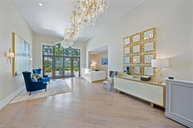 a living room with furniture or chandelier and a wooden floor