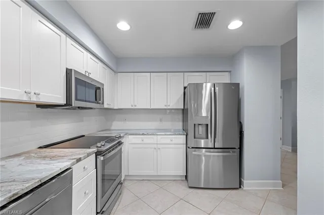 a kitchen with a refrigerator sink and microwave
