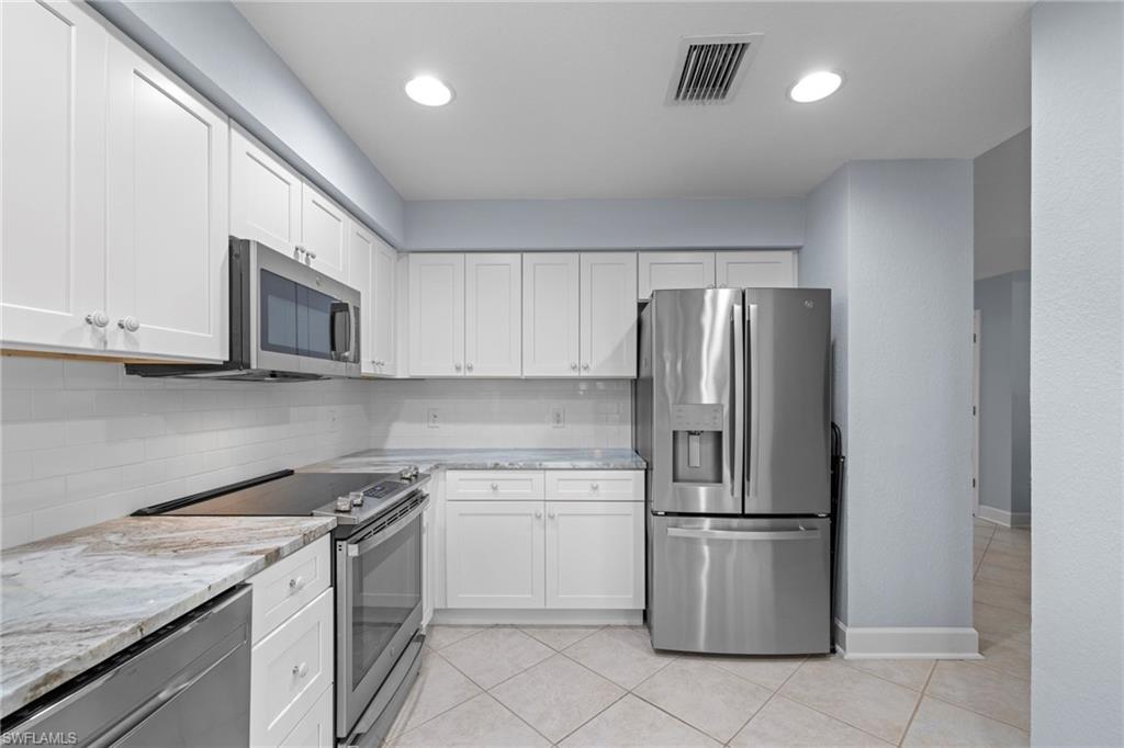 19081 Ridgepoint Drive, Unit 102 Estero, FL 33928 - Photo 5 of 50 a kitchen with a refrigerator sink and microwave