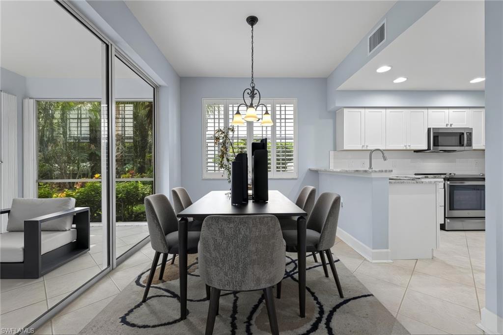 19081 Ridgepoint Drive, Unit 102 Estero, FL 33928 - Photo 6 of 50 a view of a dining room with furniture window and outside view