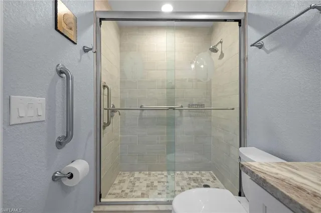 a bathroom with a shower and toilet