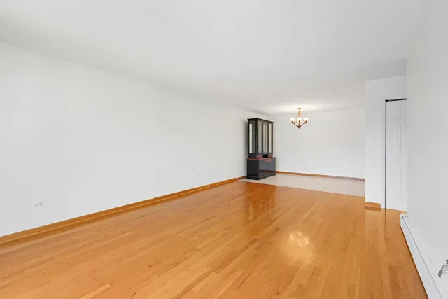 a view of an empty room and wooden floor