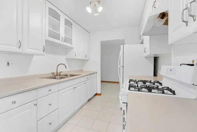 a kitchen with stainless steel appliances granite countertop a sink stove and cabinets