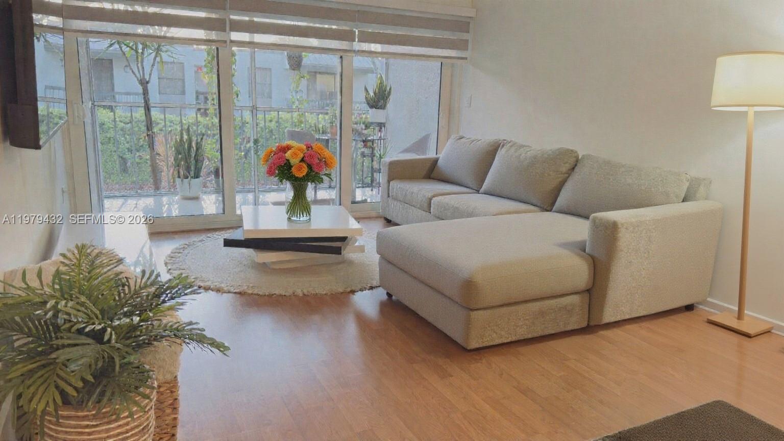a living room with furniture and a potted plant