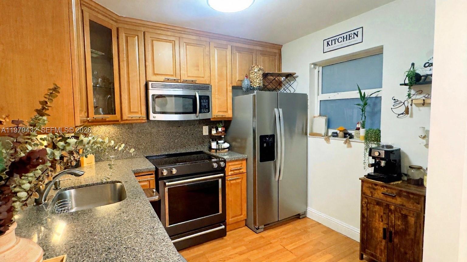 483 North Pine Island Road, Unit C205 Plantation, FL 33324 - Photo 11 of 22 a kitchen with a refrigerator stove and microwave