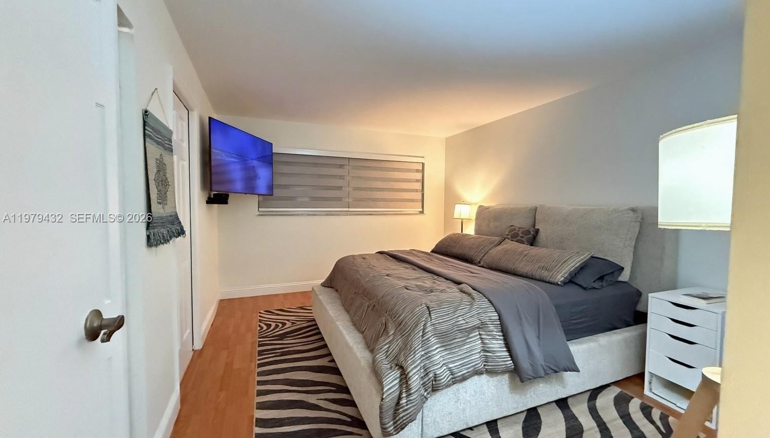 483 North Pine Island Road, Unit C205 Plantation, FL 33324 - Photo 15 of 22 a bedroom with a bed and a lamp