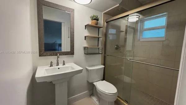 a bathroom with a toilet sink and shower