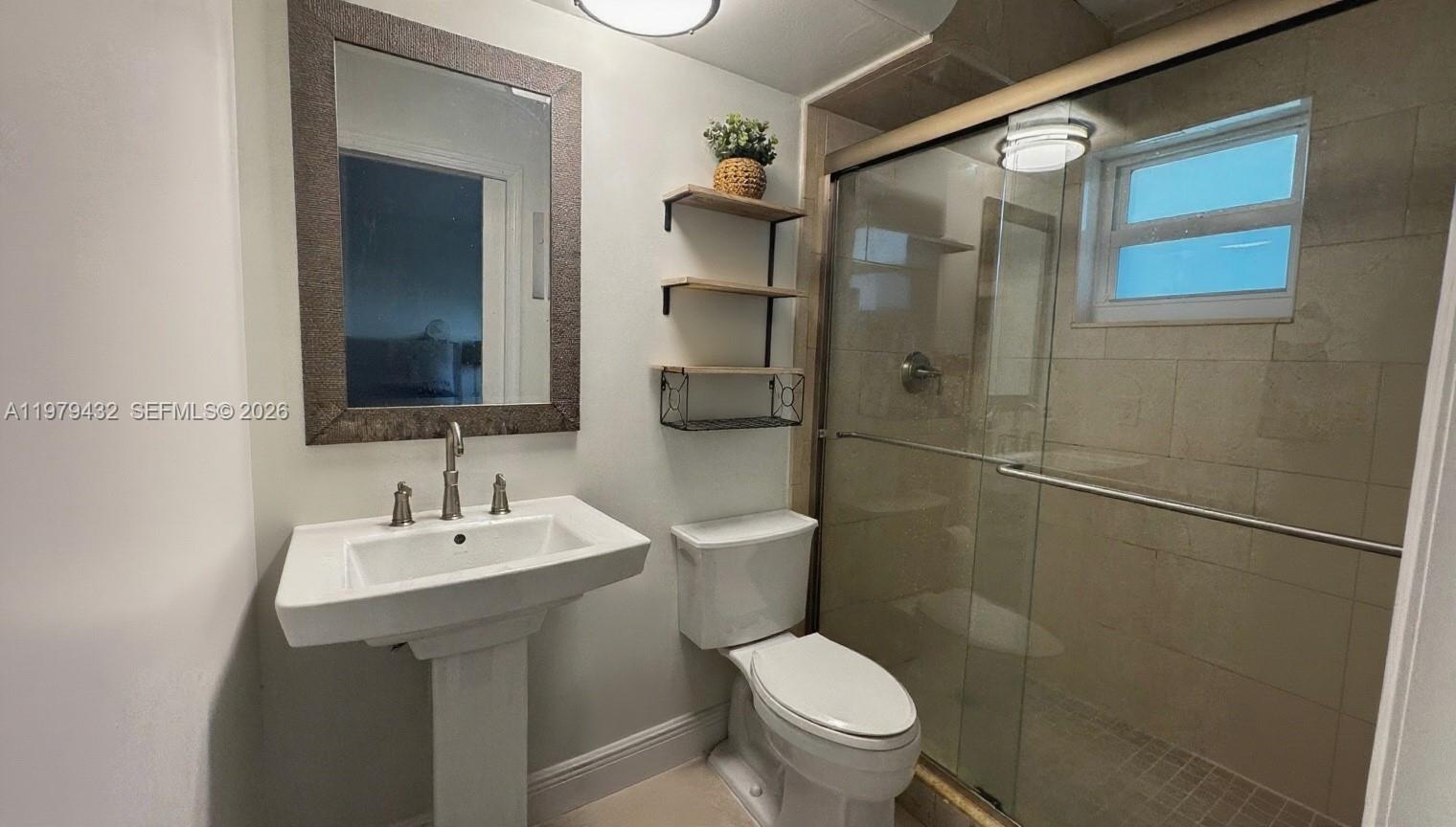 483 North Pine Island Road, Unit C205 Plantation, FL 33324 - Photo 16 of 22 a bathroom with a toilet sink and shower