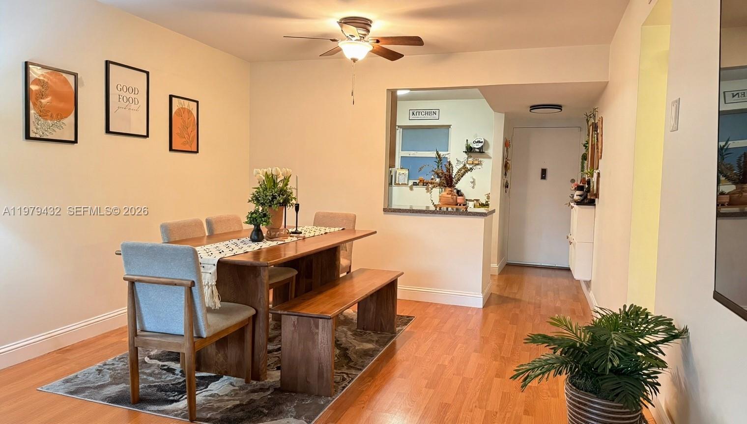483 North Pine Island Road, Unit C205 Plantation, FL 33324 - Photo 7 of 22 a view of a dining room with furniture and a chandelier fan