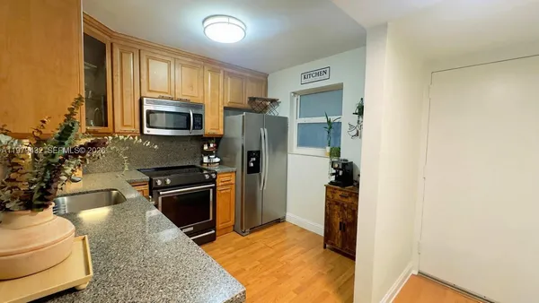 a kitchen with a refrigerator stove and microwave