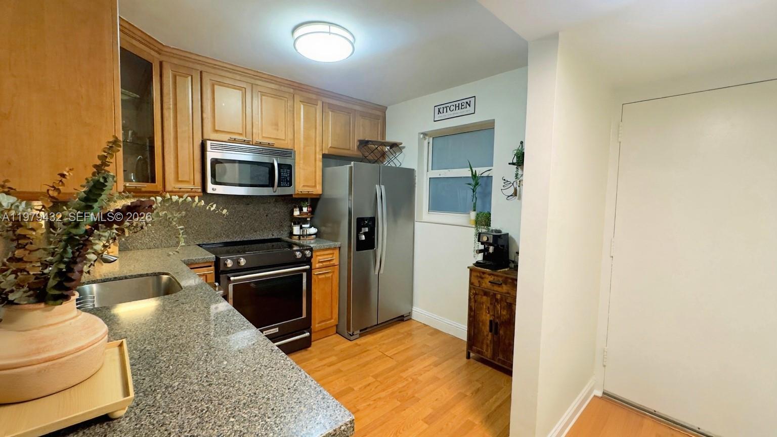 483 North Pine Island Road, Unit C205 Plantation, FL 33324 - Photo 10 of 22 a kitchen with a refrigerator stove and microwave