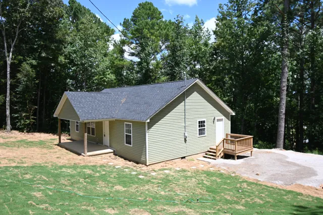 a backyard of a house with table and chairs