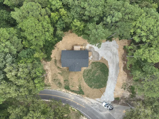 an aerial view of a house with a yard