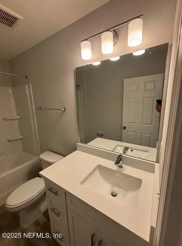 a room with a sink a washer and dryer