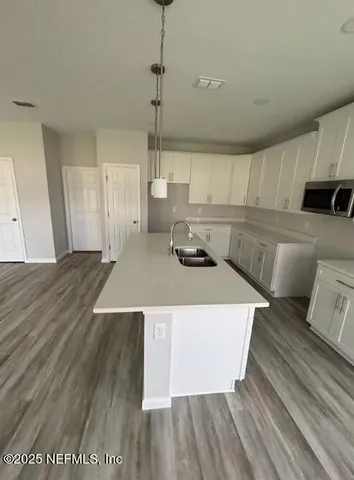 a view of a room with wooden floor