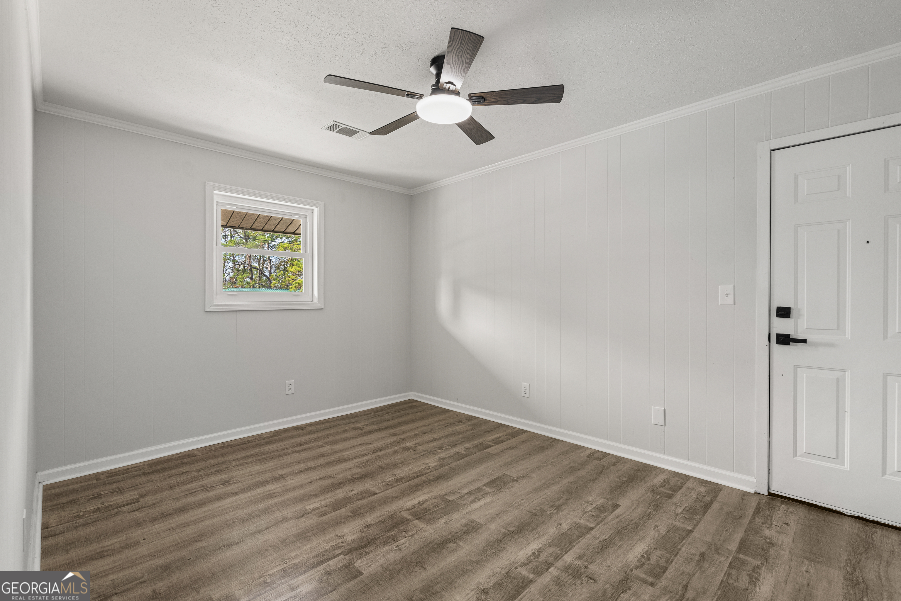 2312 Burnside Drive Columbus, GA 31907 - Photo 13 of 29 an empty room with wooden floor and ceiling fan