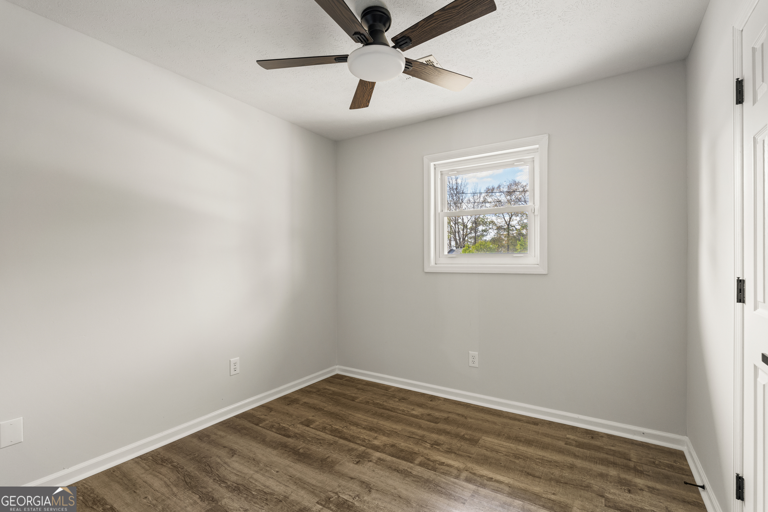 2312 Burnside Drive Columbus, GA 31907 - Photo 17 of 29 an empty room with wooden floor and ceiling fan