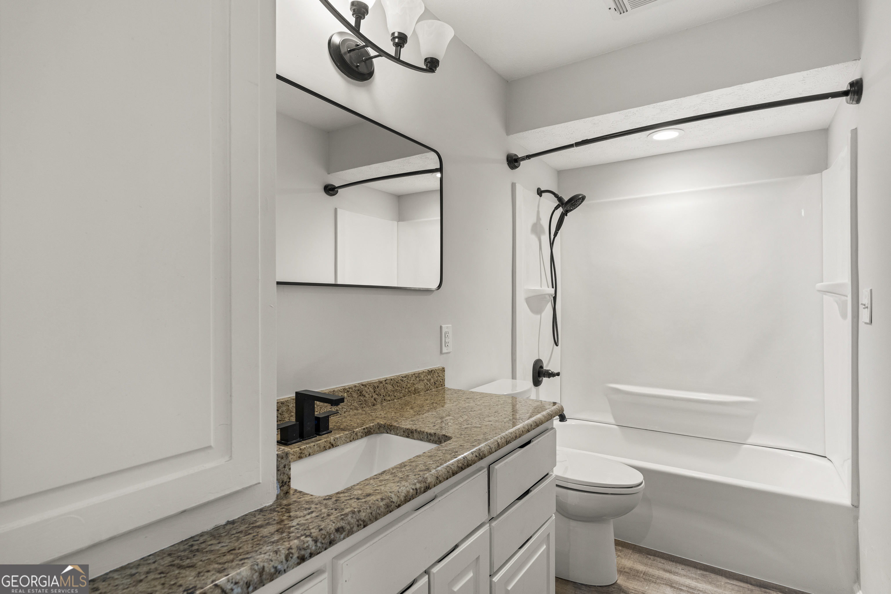 2312 Burnside Drive Columbus, GA 31907 - Photo 19 of 29 a bathroom with a granite countertop sink toilet and shower