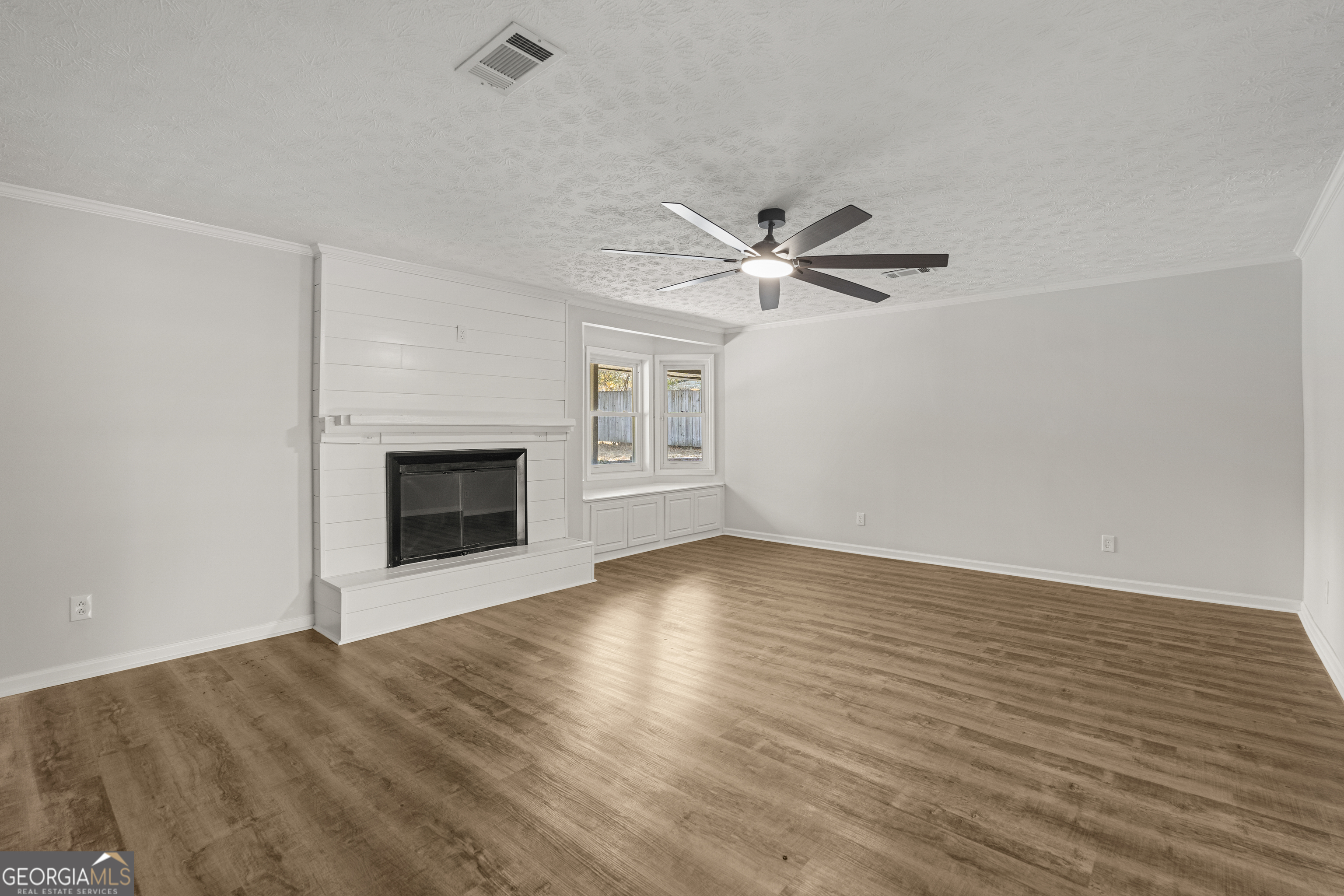2312 Burnside Drive Columbus, GA 31907 - Photo 5 of 29 wooden floor in an empty room with a fireplace