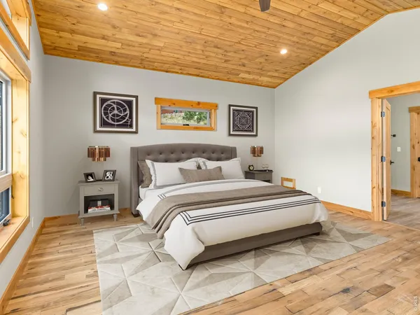 a spacious bedroom with a bed and a painting on the wall