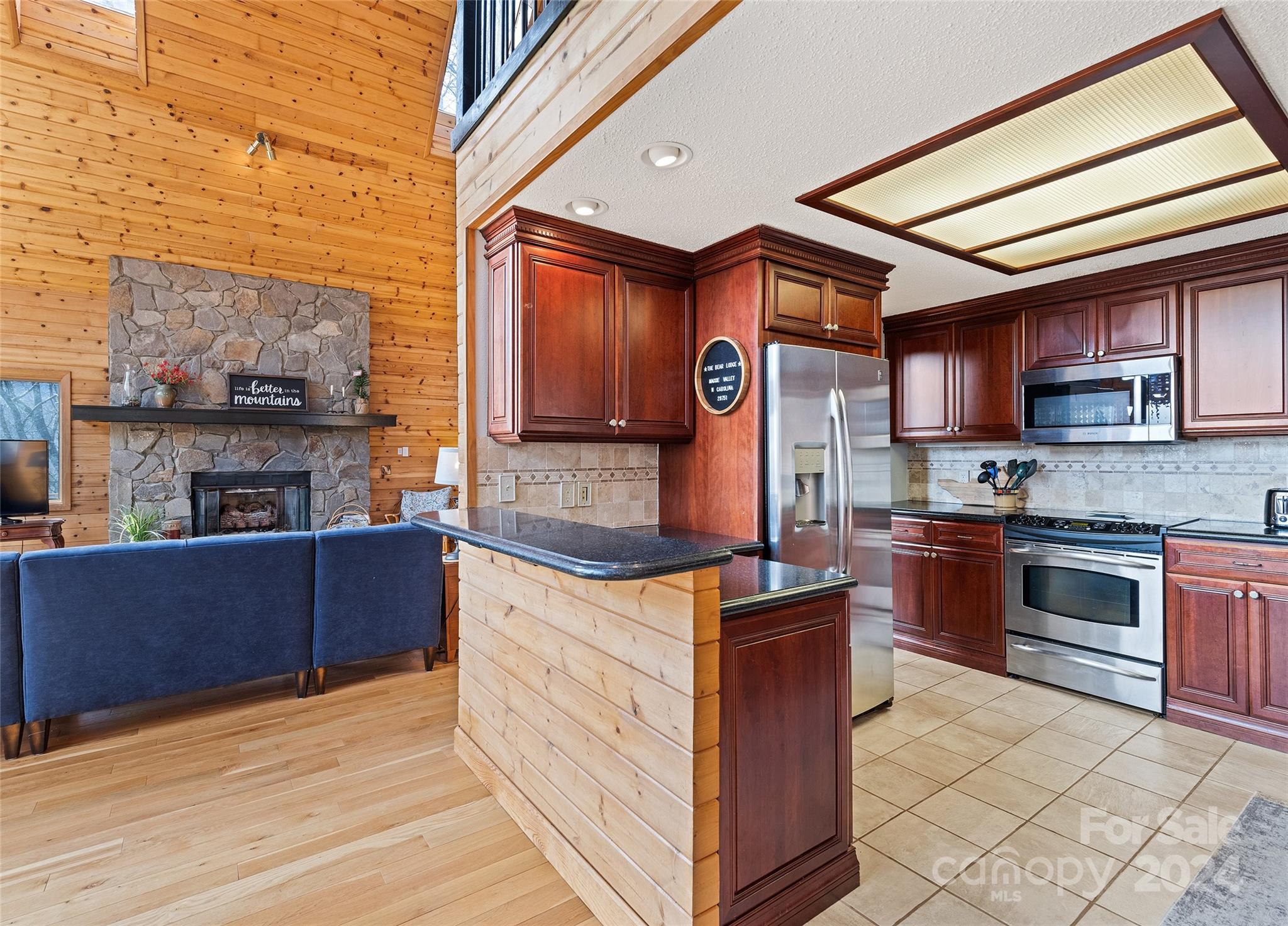 2521 Pless Underwood Road Maggie Valley, NC 28751 - Photo 12 of 46 a kitchen with stainless steel appliances granite countertop a stove a sink and a refrigerator