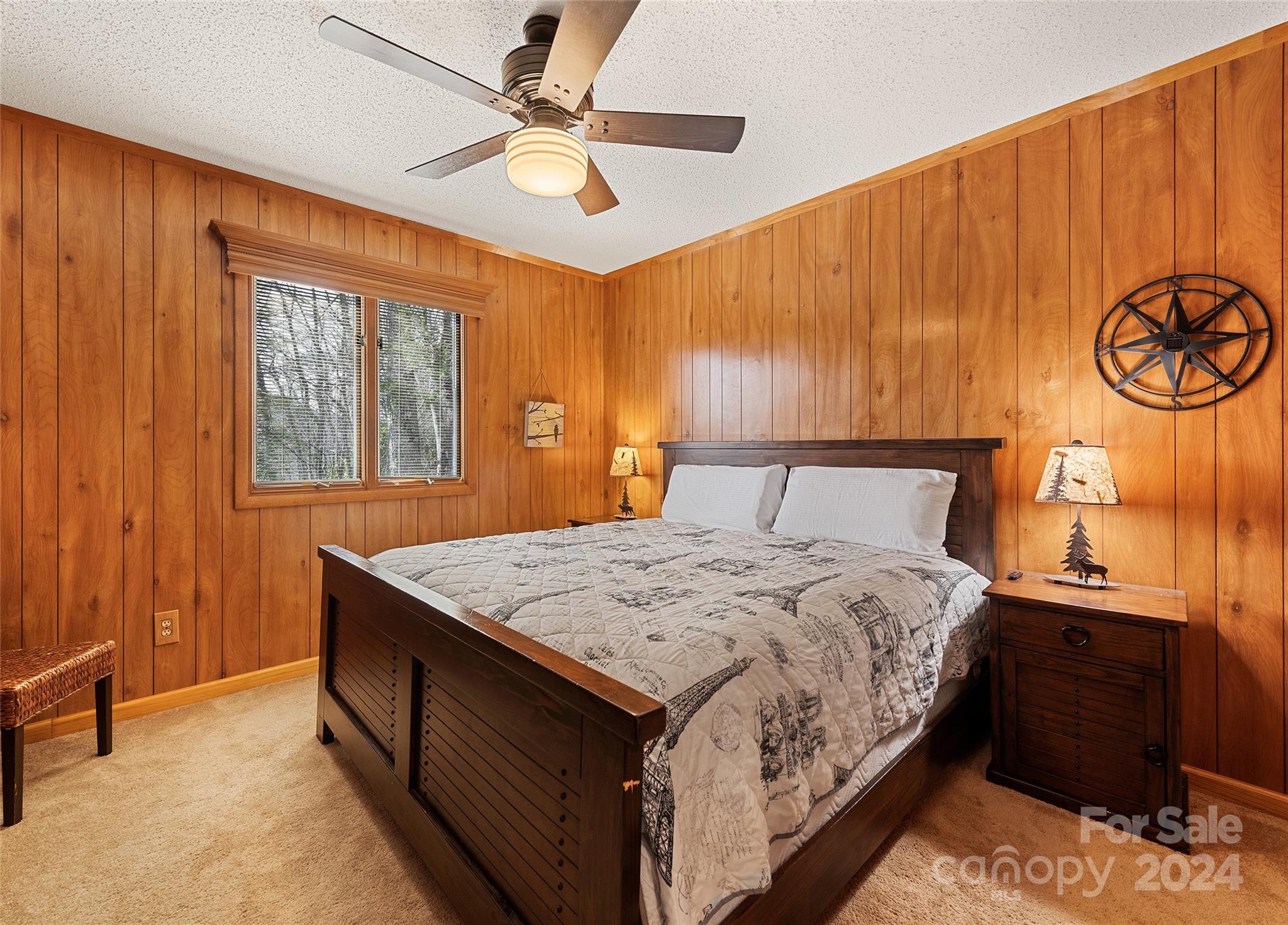 2521 Pless Underwood Road Maggie Valley, NC 28751 - Photo 17 of 46 a bedroom with a bed and a chandelier