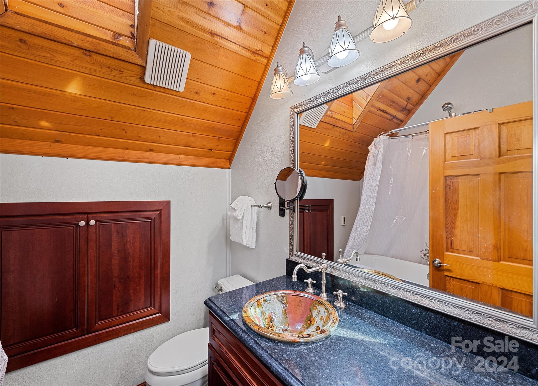 2521 Pless Underwood Road Maggie Valley, NC 28751 - Photo 25 of 46 a bathroom with a granite countertop sink and a mirror