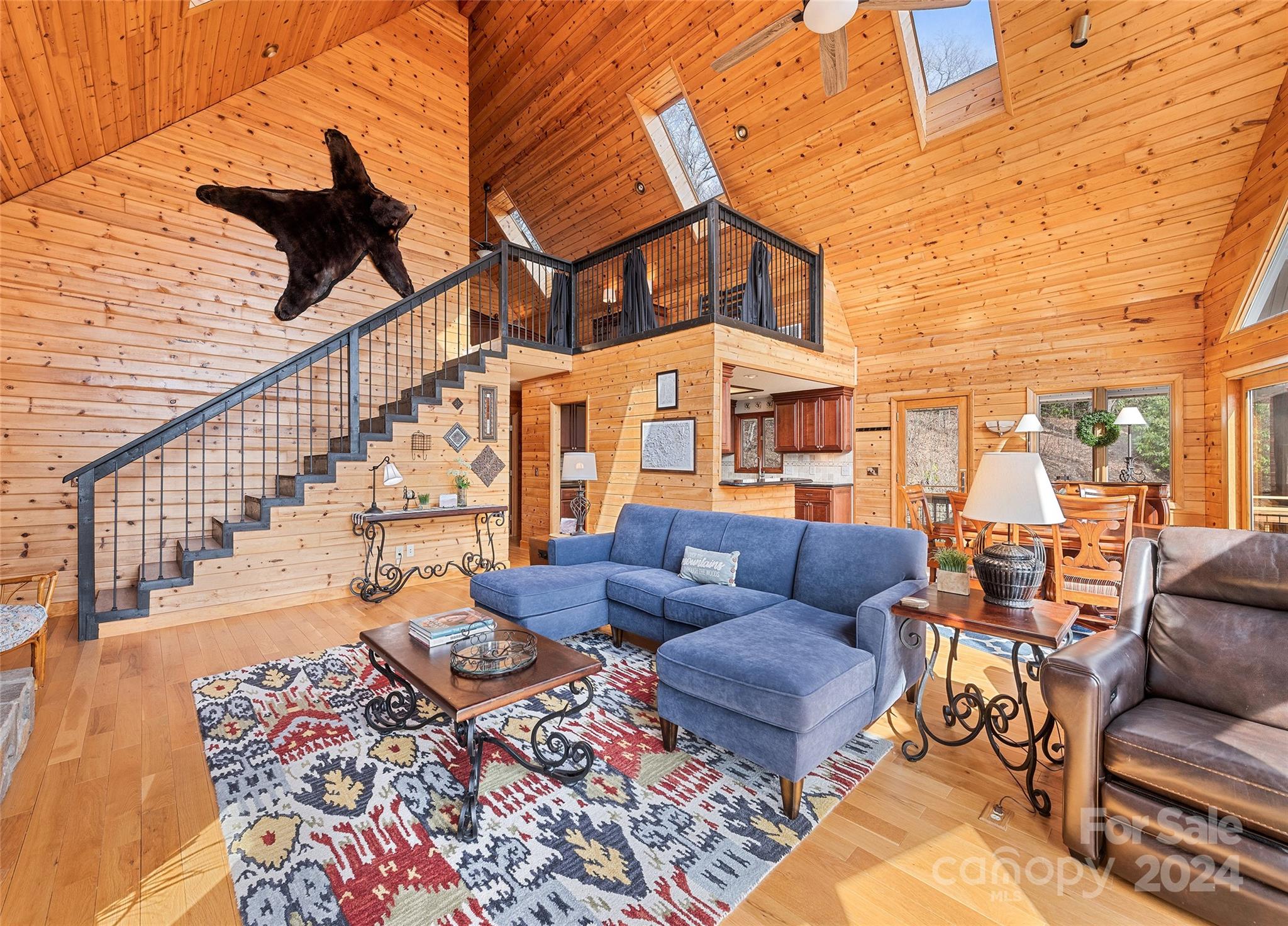 2521 Pless Underwood Road Maggie Valley, NC 28751 - Photo 10 of 46 a view of a patio with couches table and chairs with wooden floor