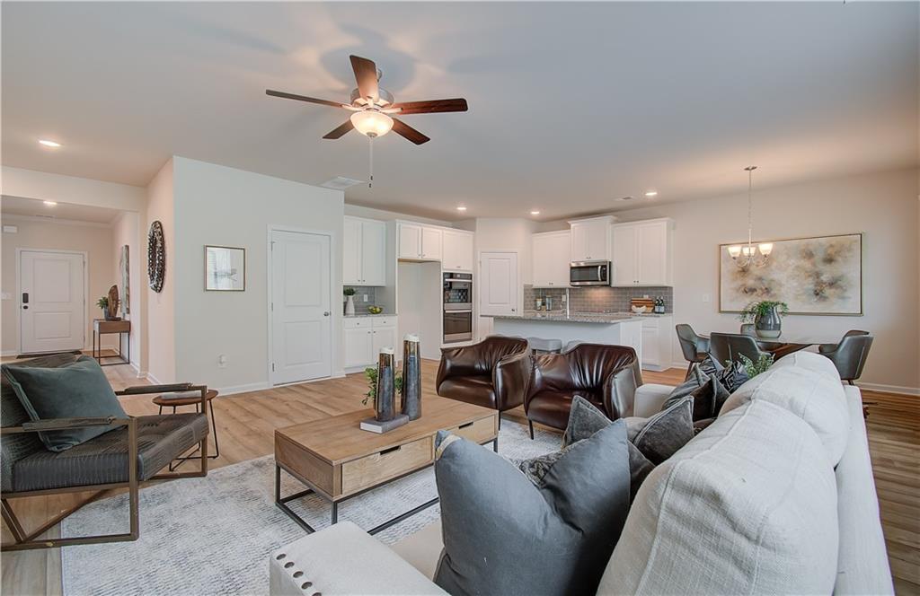 467 Collier Mls Road Lawrenceville, GA 30045 - Photo 15 of 39 a living room with furniture kitchen view and a chandelier