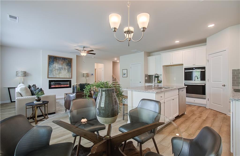 467 Collier Mls Road Lawrenceville, GA 30045 - Photo 20 of 39 a view of a dining room with furniture a livingroom and chandelier