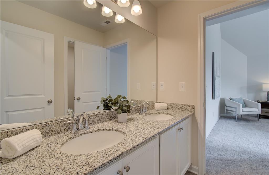 467 Collier Mls Road Lawrenceville, GA 30045 - Photo 25 of 39 a bathroom with a granite countertop sink and a mirror