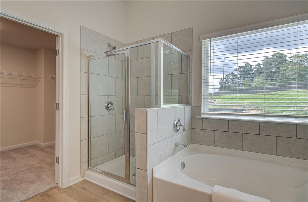 467 Collier Mls Road Lawrenceville, GA 30045 - Photo 37 of 39 a bathroom with a bathtub and shower