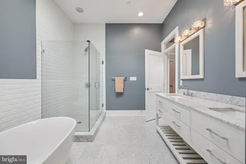 a bathroom with a tub sink and mirror