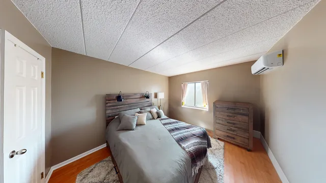 a bedroom with a bed and window