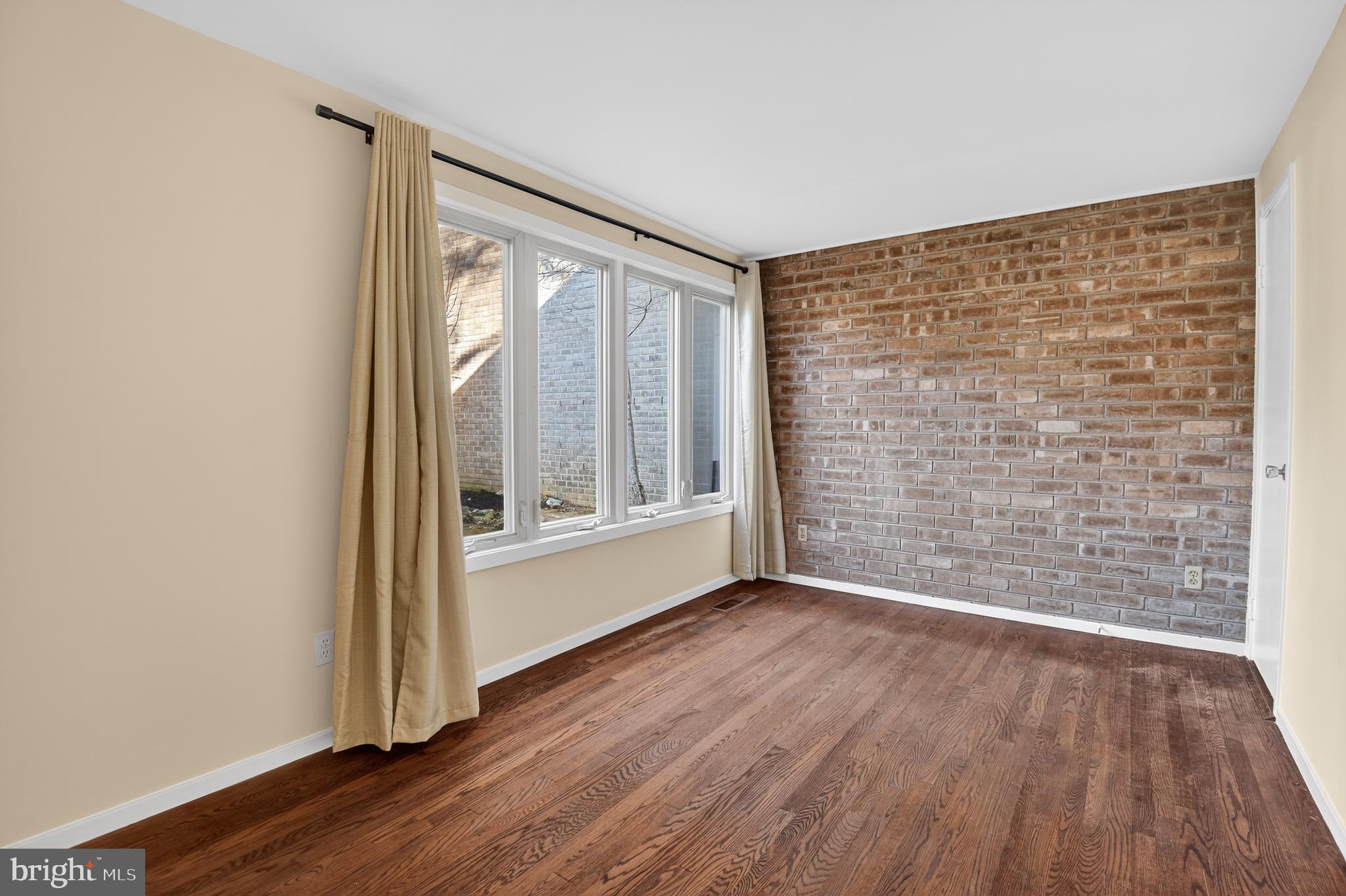 19144 Roman Way Gaithersburg, MD 20886 - Photo 14 of 31 a view of an empty room with wooden floor and a window