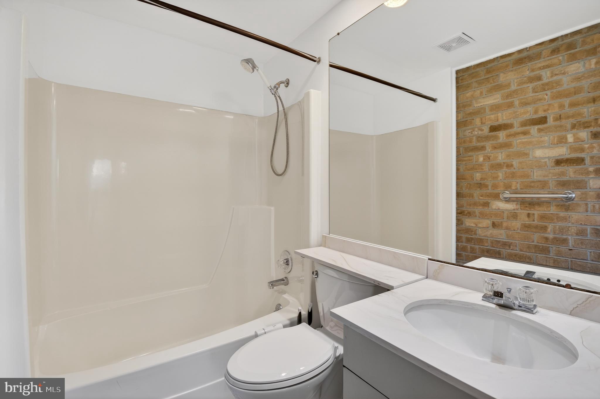 19144 Roman Way Gaithersburg, MD 20886 - Photo 15 of 31 a bathroom with a sink toilet and shower